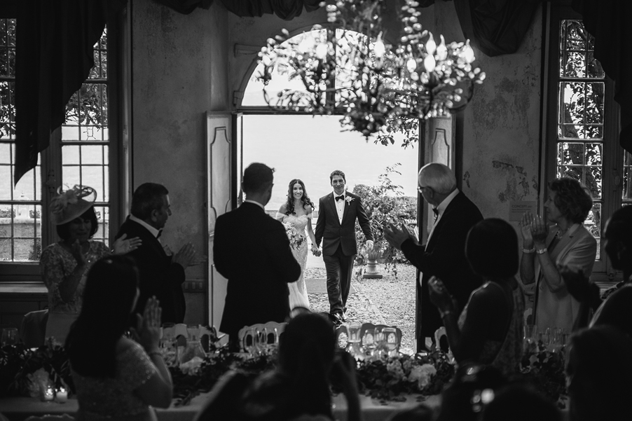 Bride-and-groom-enter-the-villa-dining-room-at-Villa-Regina-Teodolinda-wedding-planner-Gemma-Aurelius