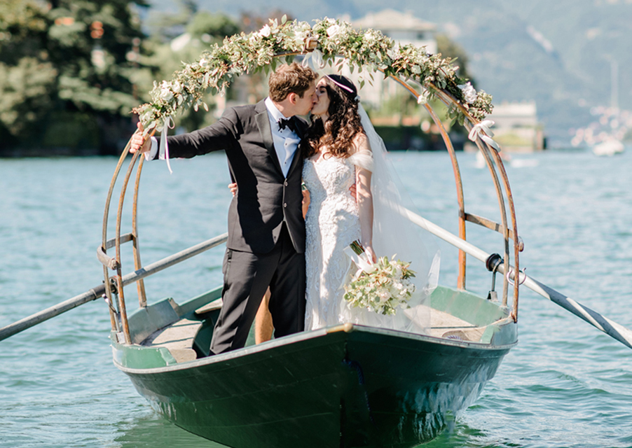 Bride-and-groom-on-Lucia-row-boat-on-Lake-Como-in-Italy-for-wedding-day